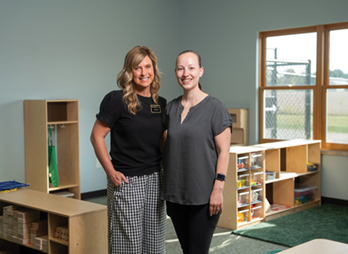 Two Purdue Extension childcare educators standing in a classroom.