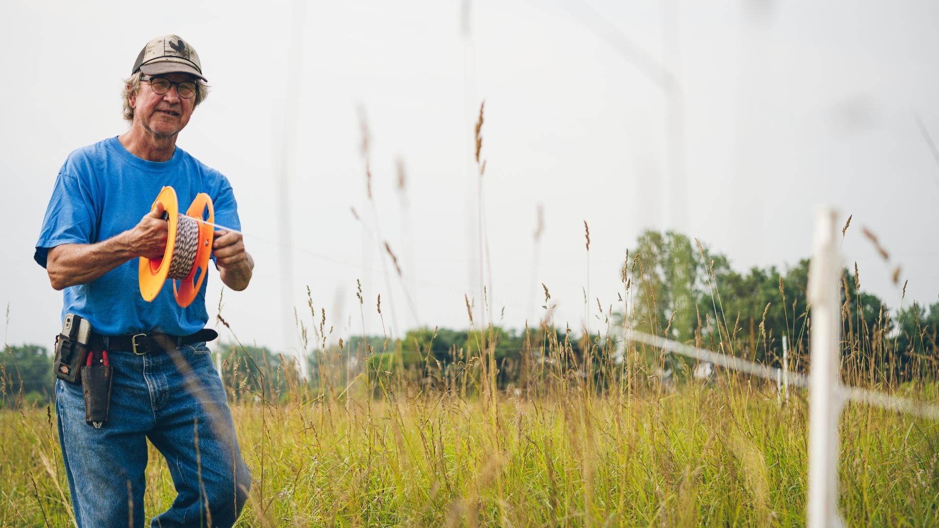 Image of a man surveying in a field.