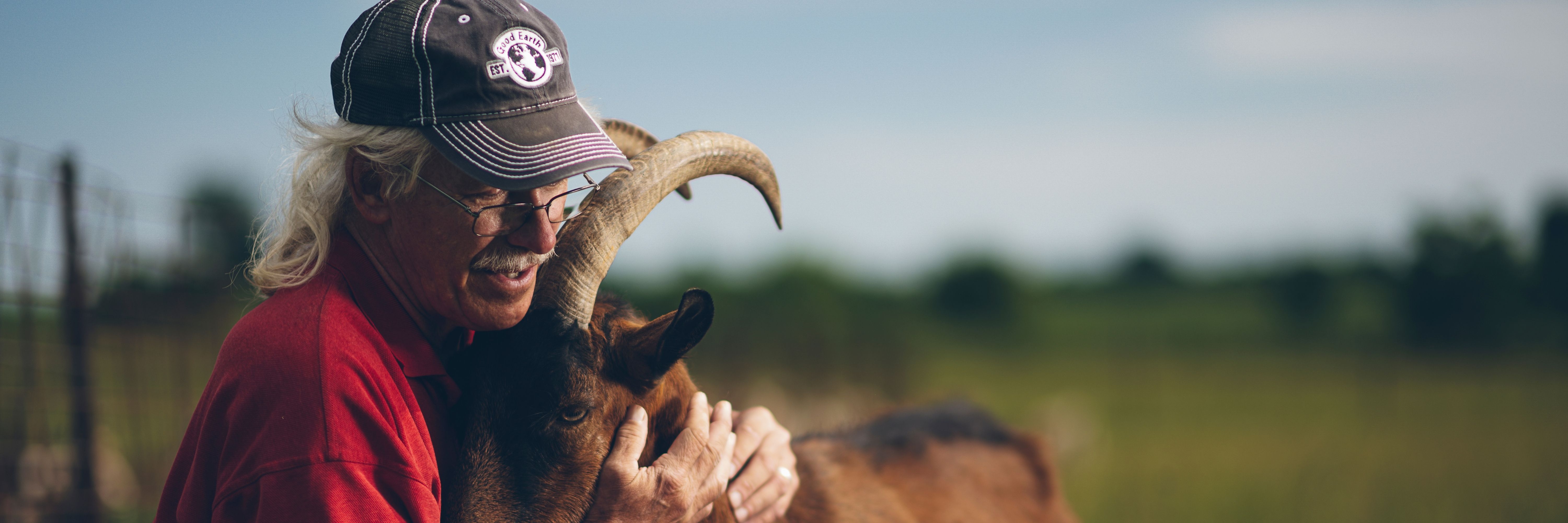 Man Holding a Goat