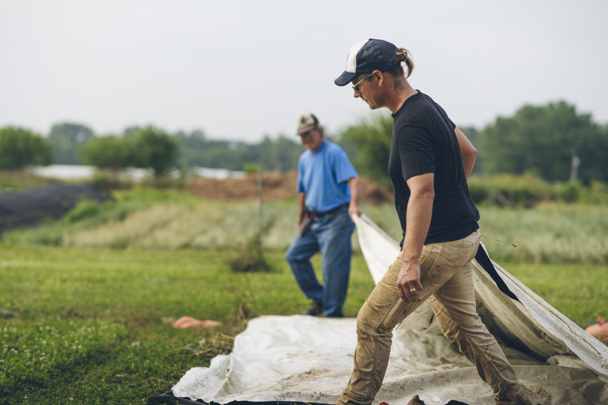 Photo of couple standing next to barn.