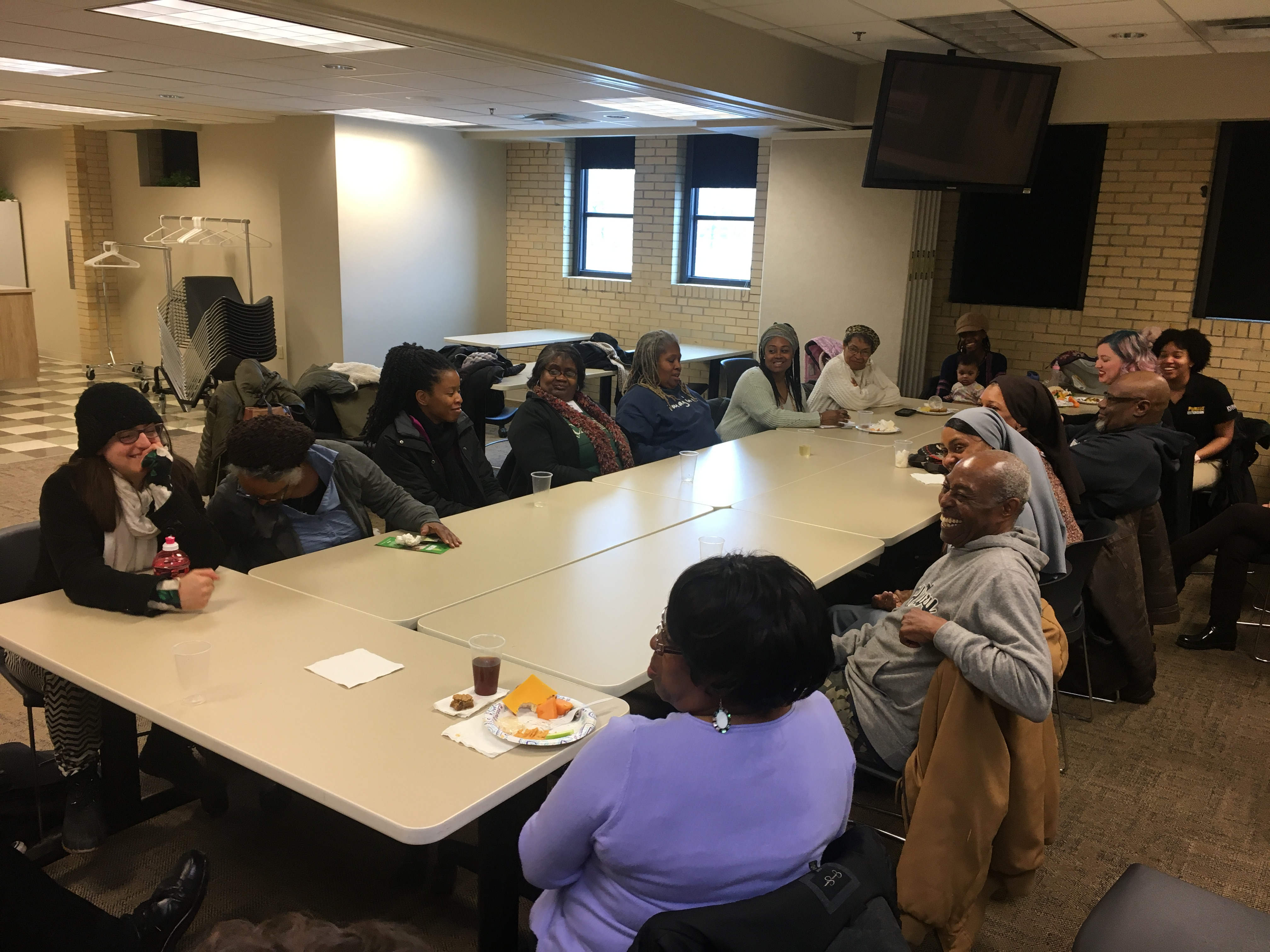 image of several SFC attendees talking while sitting at a table.