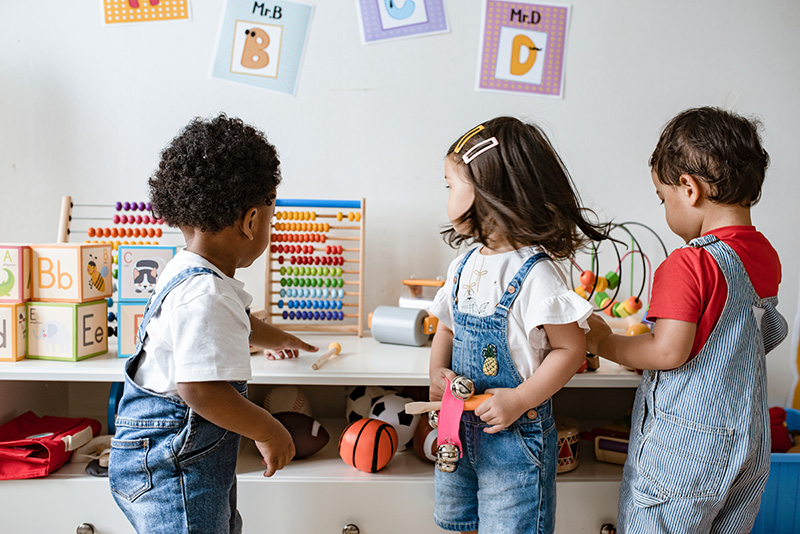 three children playing at a childcare facility
