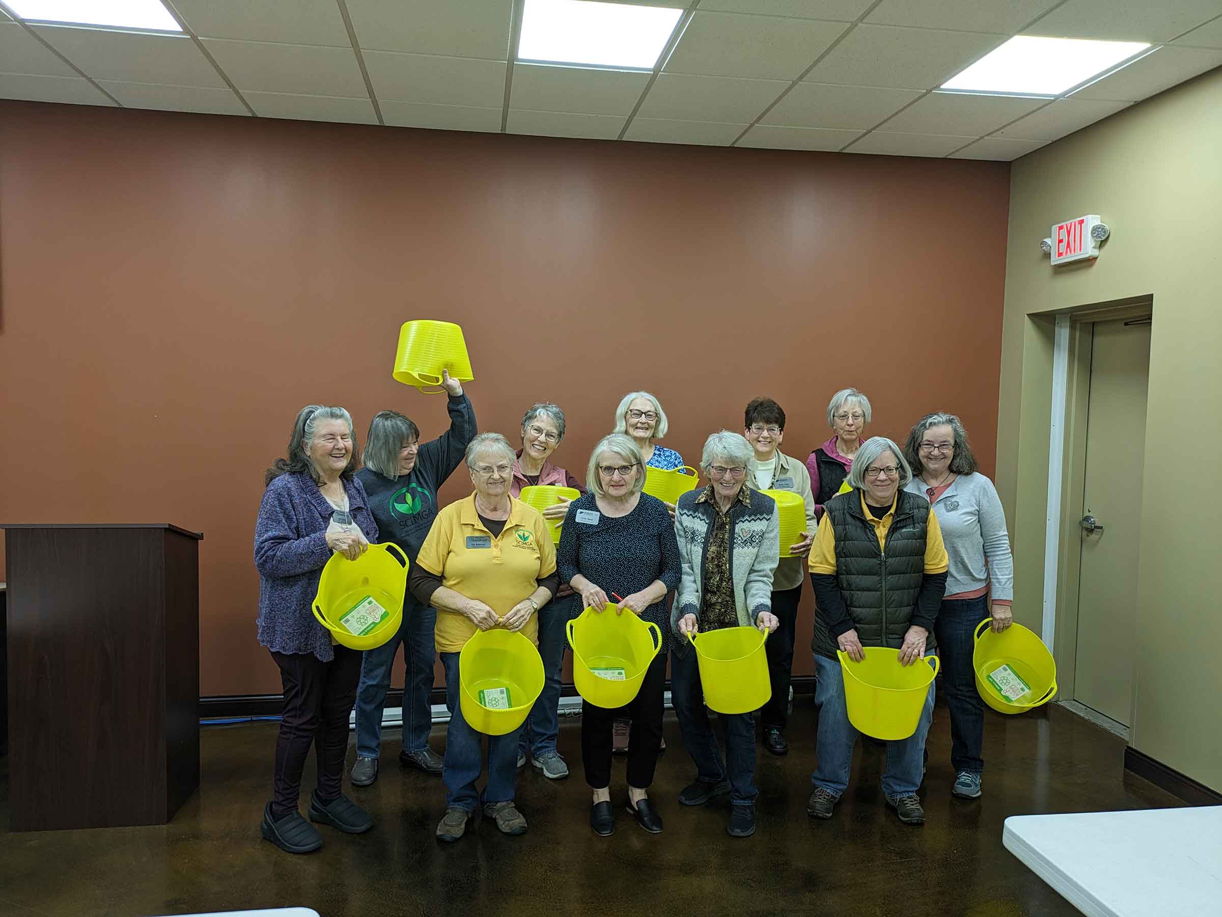 group of extension master gardeners with yellow buckets