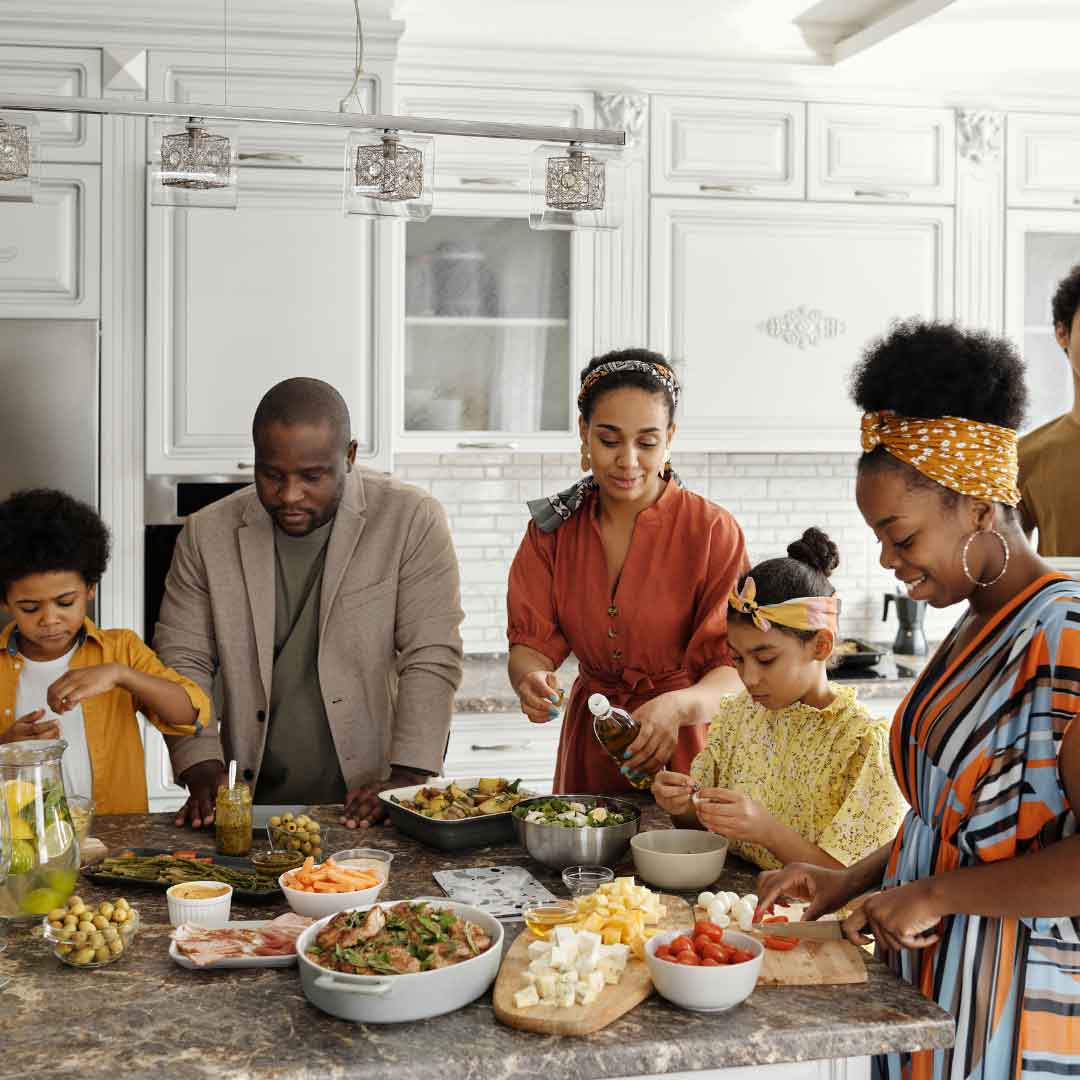 family cooking in kitchen together