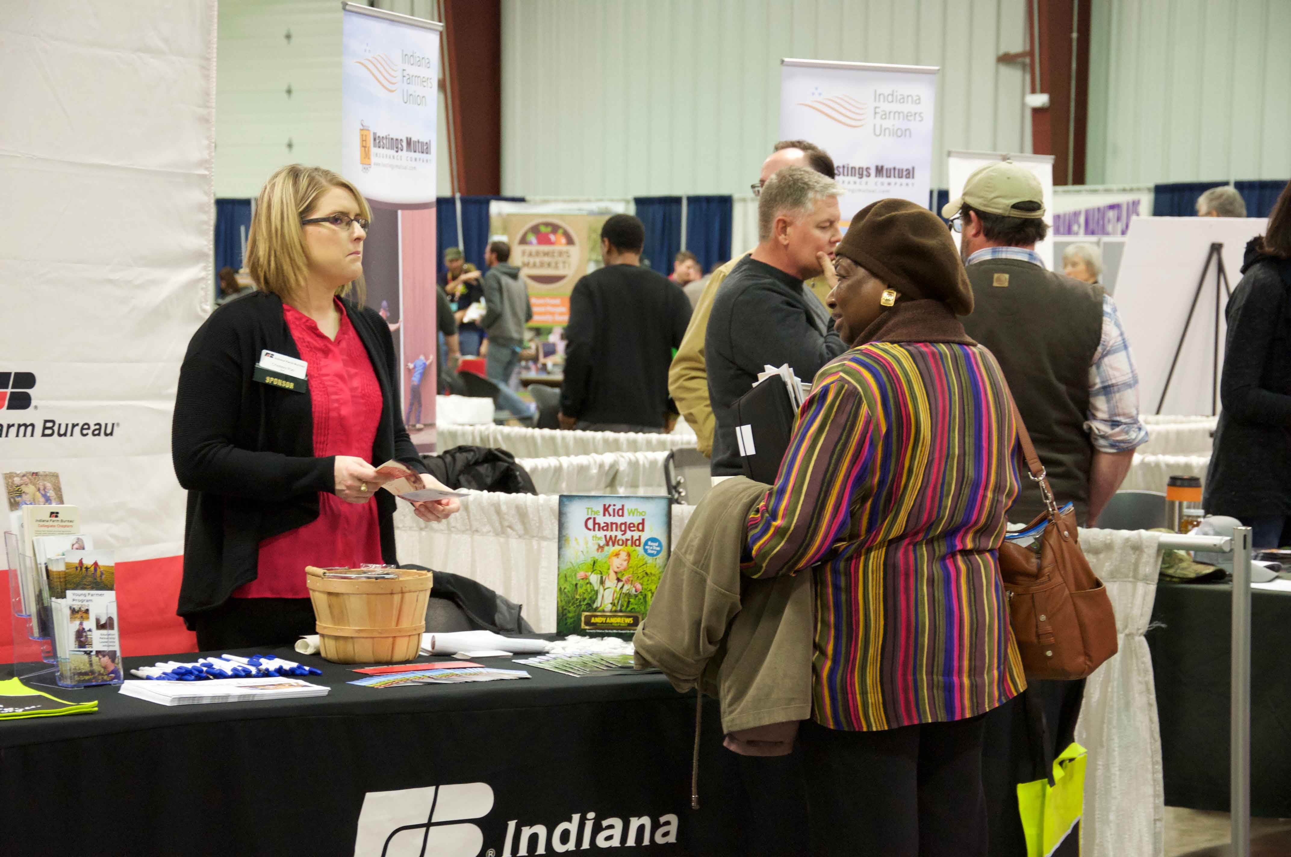 two people talking at information booth