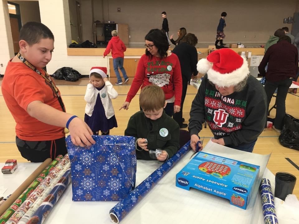 club members practicing giftwrapping