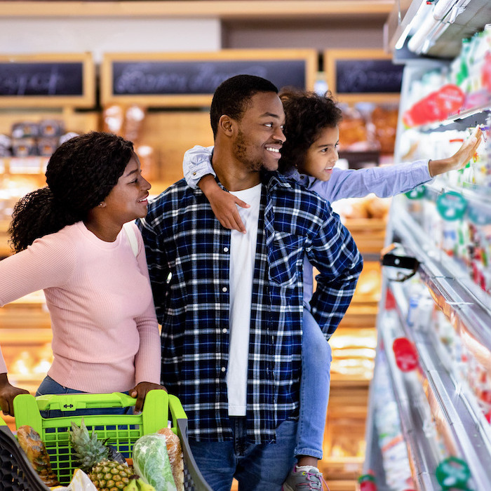 young couple with a child shopping in the supermarket