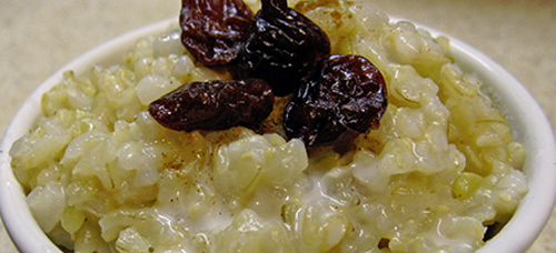 white rice pudding with risings at the top