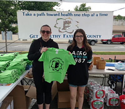 two girls showing a t-shirt
