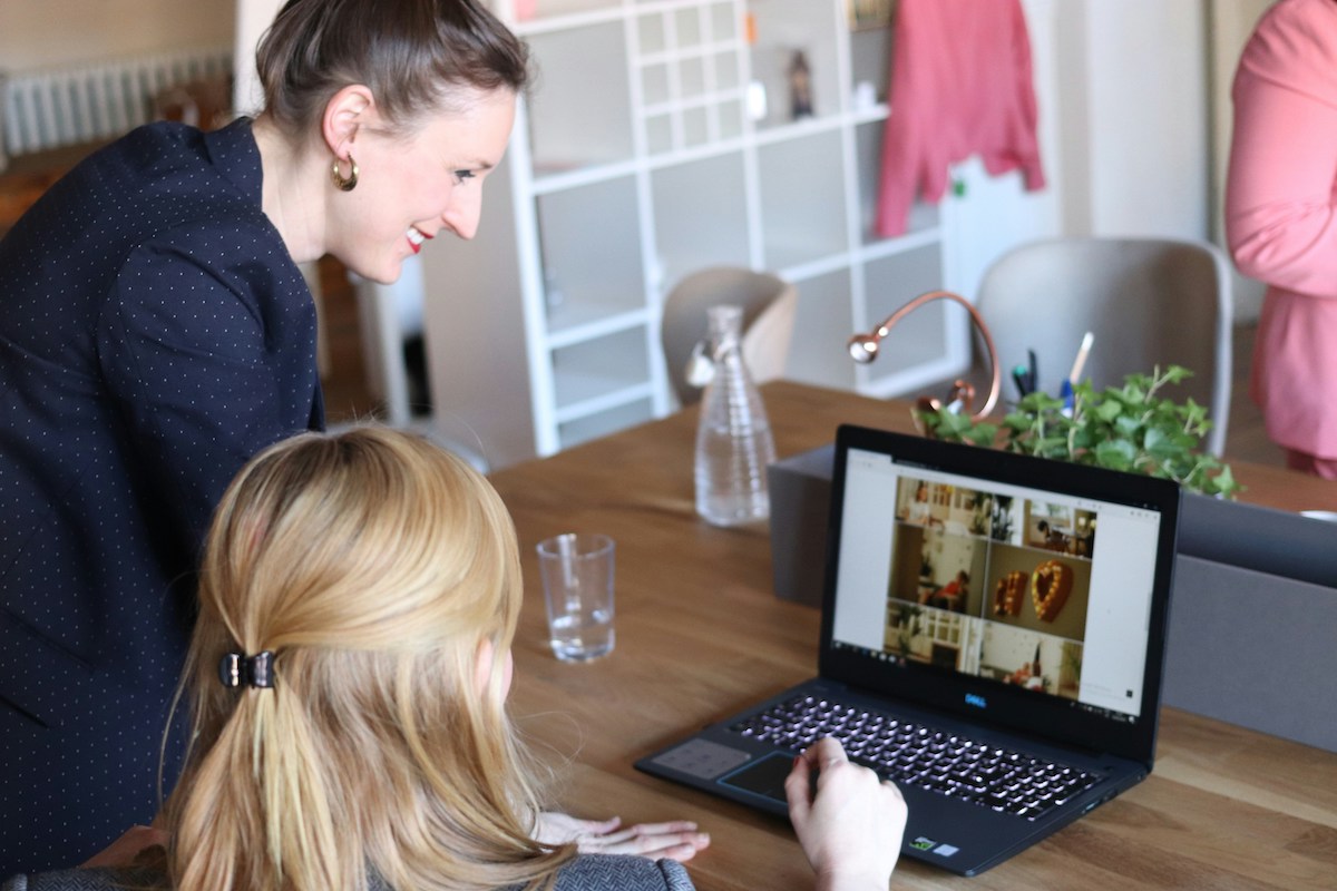 two woman working on a computer