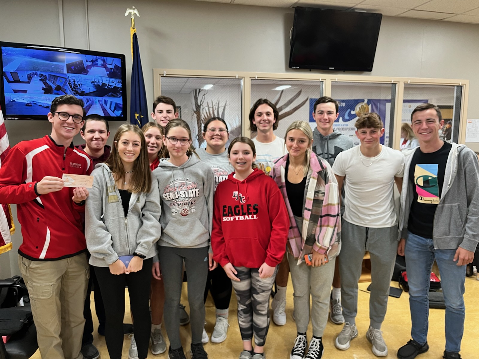 Photo of Madison County 4-H Junior Leaders at Frankton High School presenting the school a check for $250. 