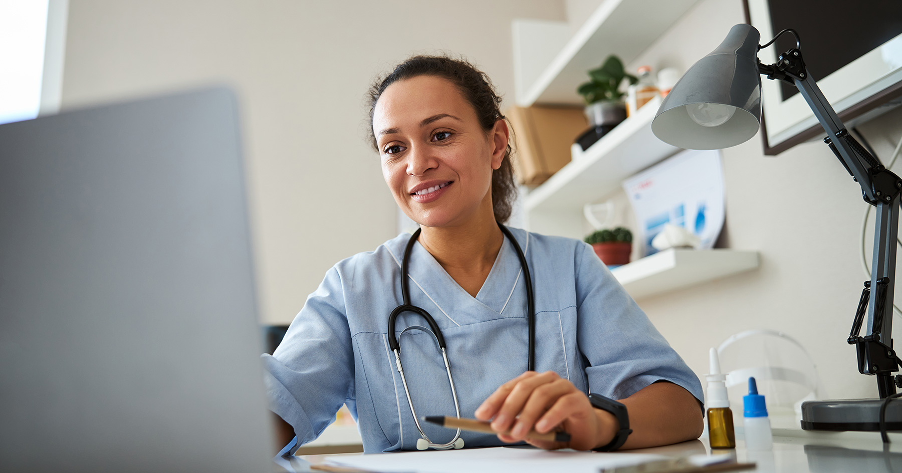 healthcare professional working on the computer