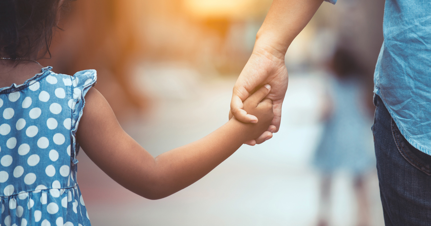 parent holding hands with child