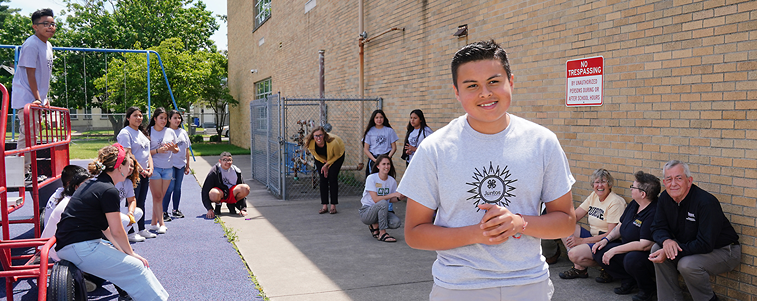 juntos youth smiling near a playground