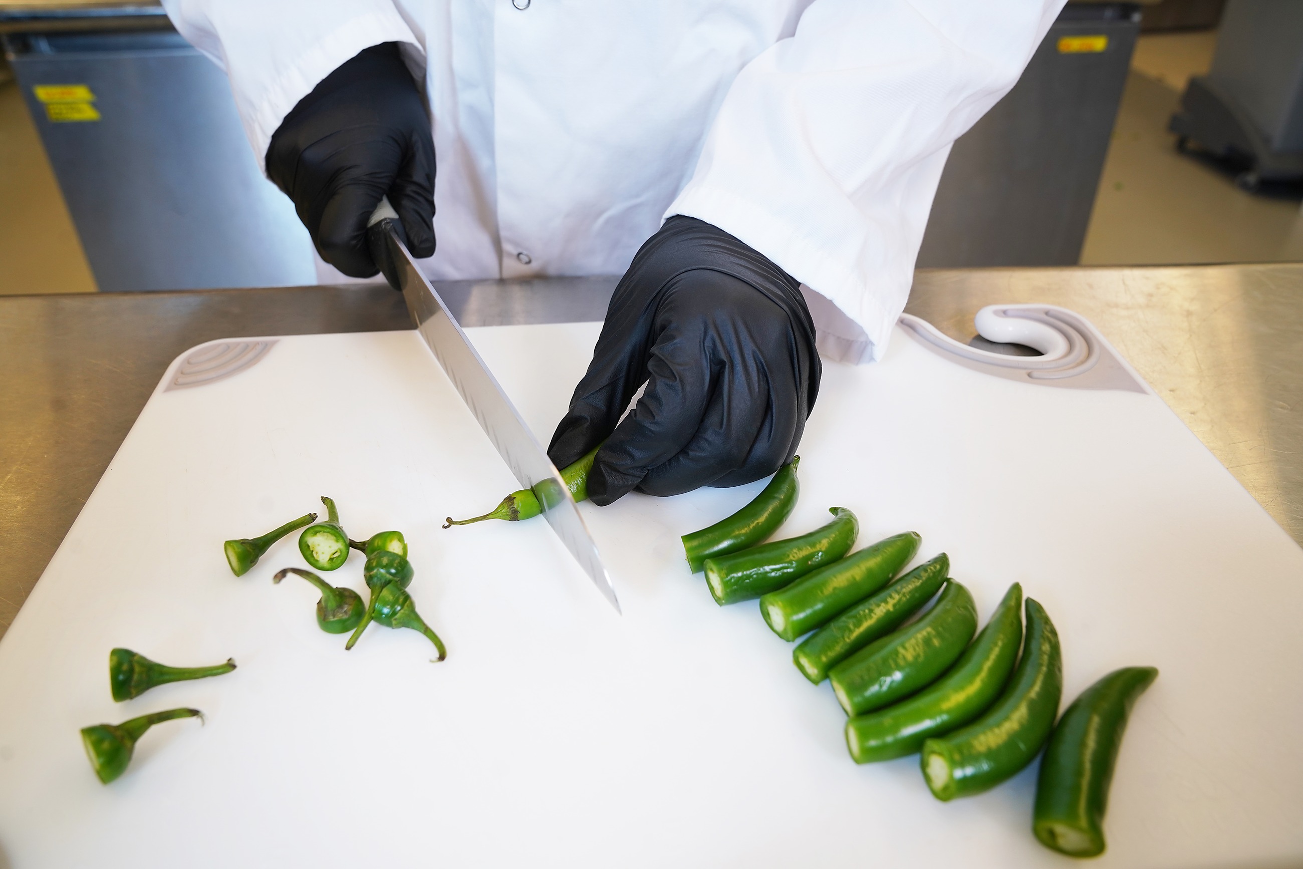 A person is cutting food safely.