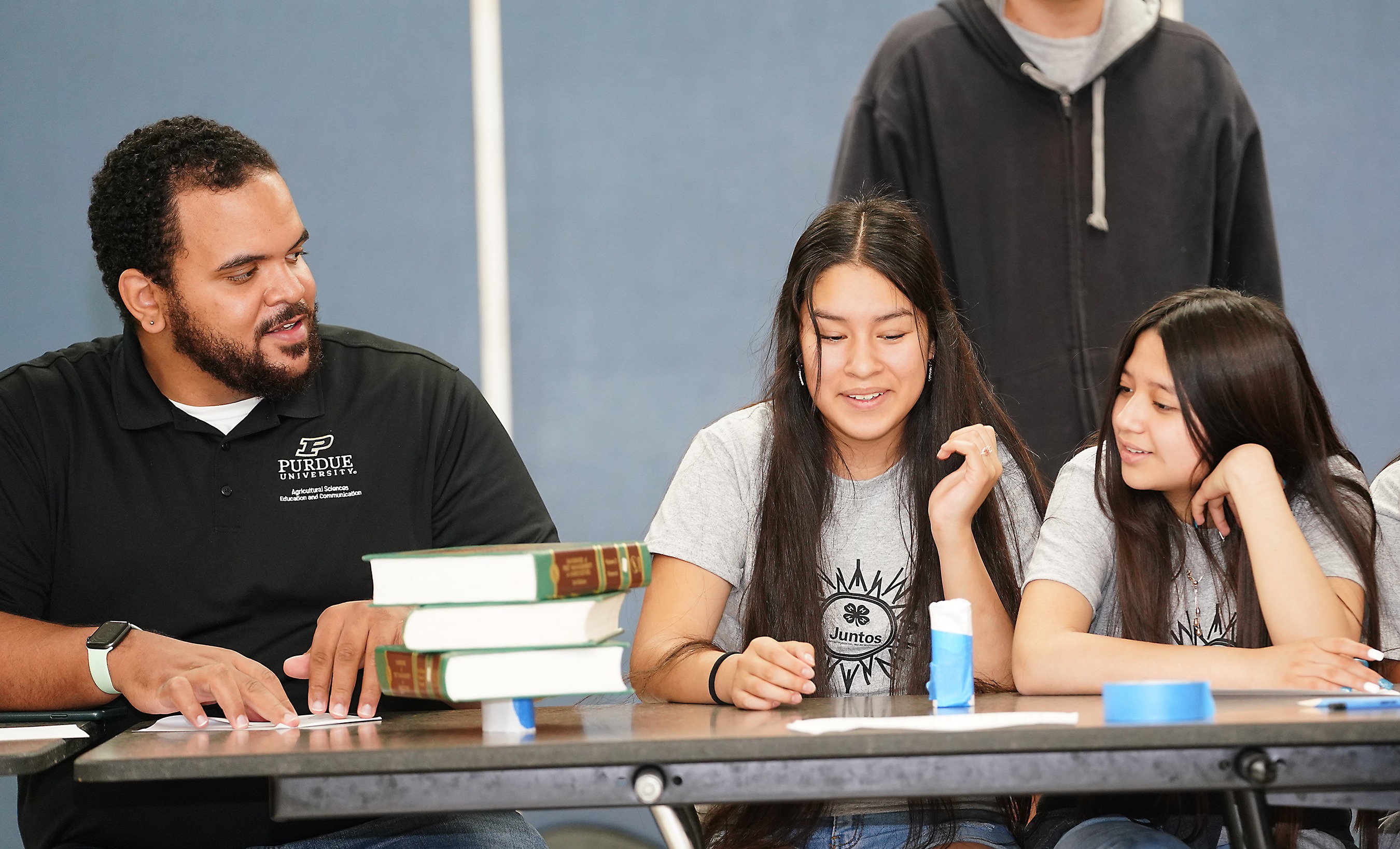 Juntos 4-H students talk with a volunteer during an activity (Photo provided by Indiana 4-H)