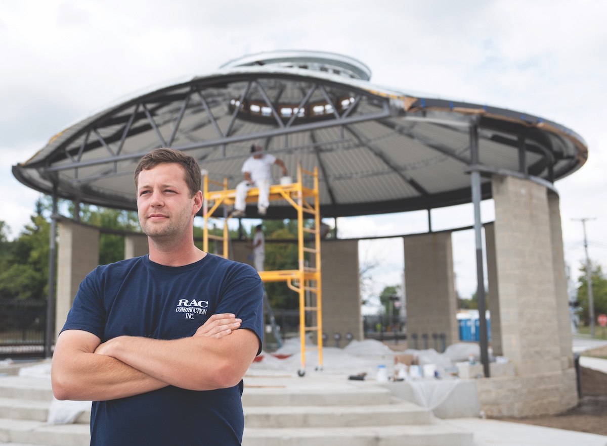 male standing in front of a building structure