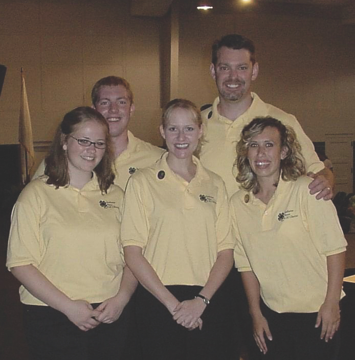 Group of people gather smiling at the camera