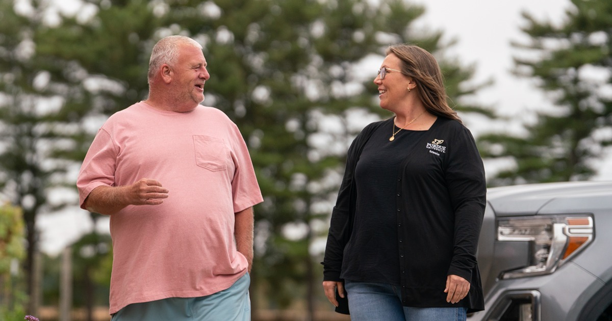 A Purdue Extension educator walks with a man attending the Food is Medicine program in Indiana.