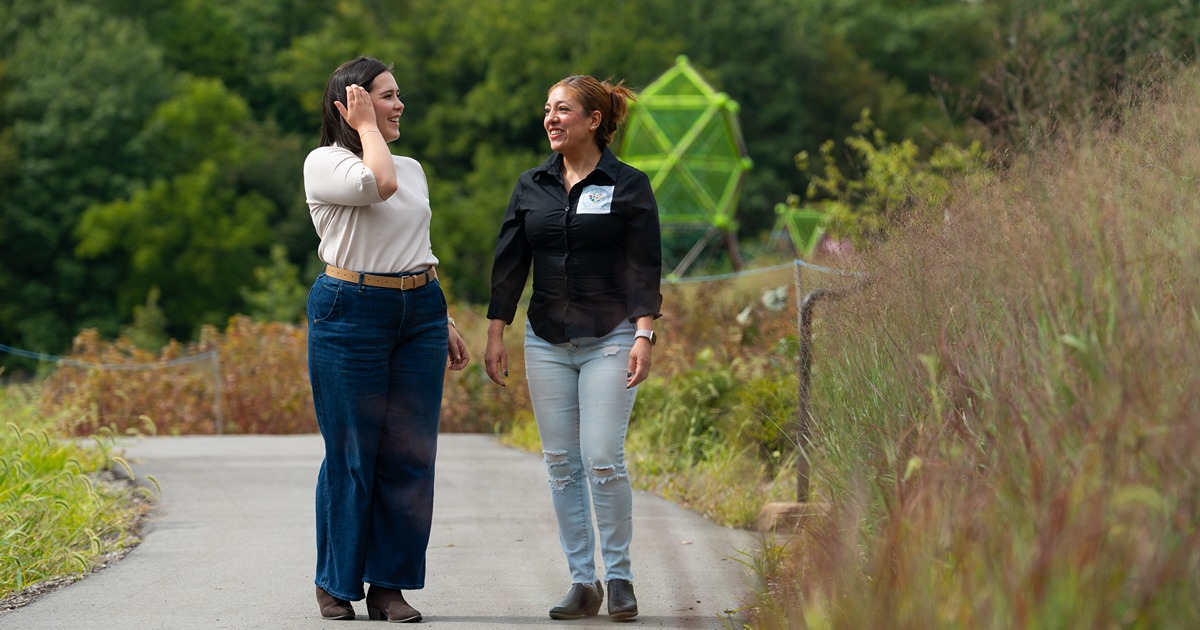 Purdue Extension Childcare Team, two women walking in a park and talking