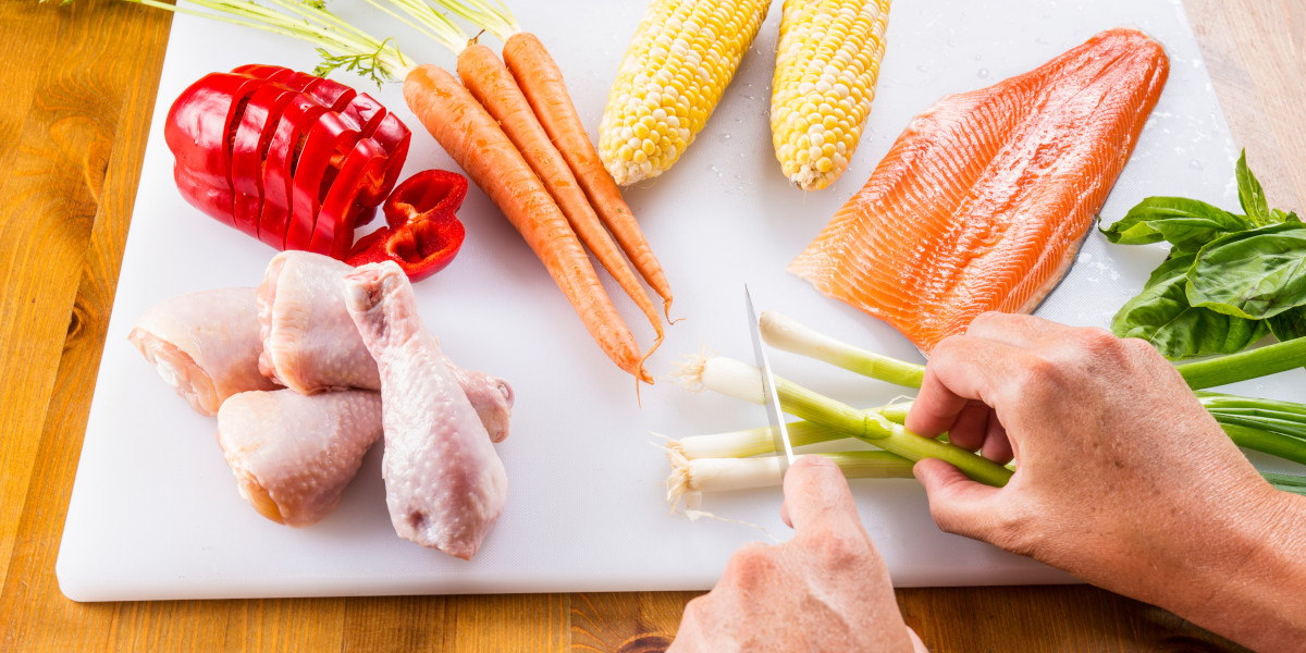 cutting meat and vegetables on cutting board