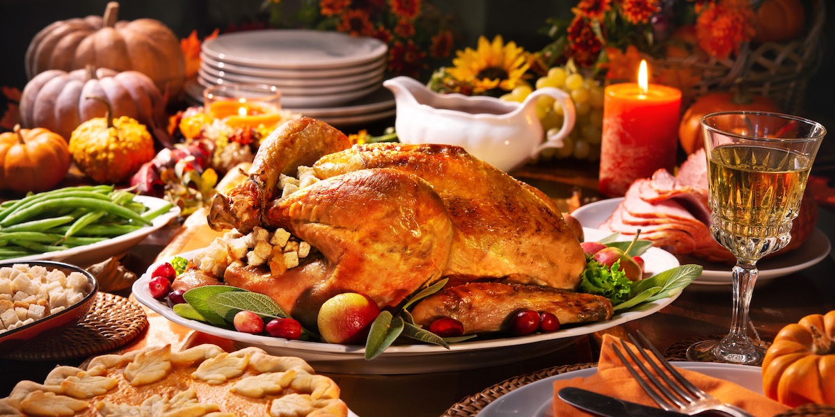Thanksgiving classic  dinner table with a turkey as a main dish