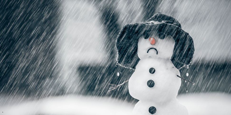 Sad snowman outside with a black hat