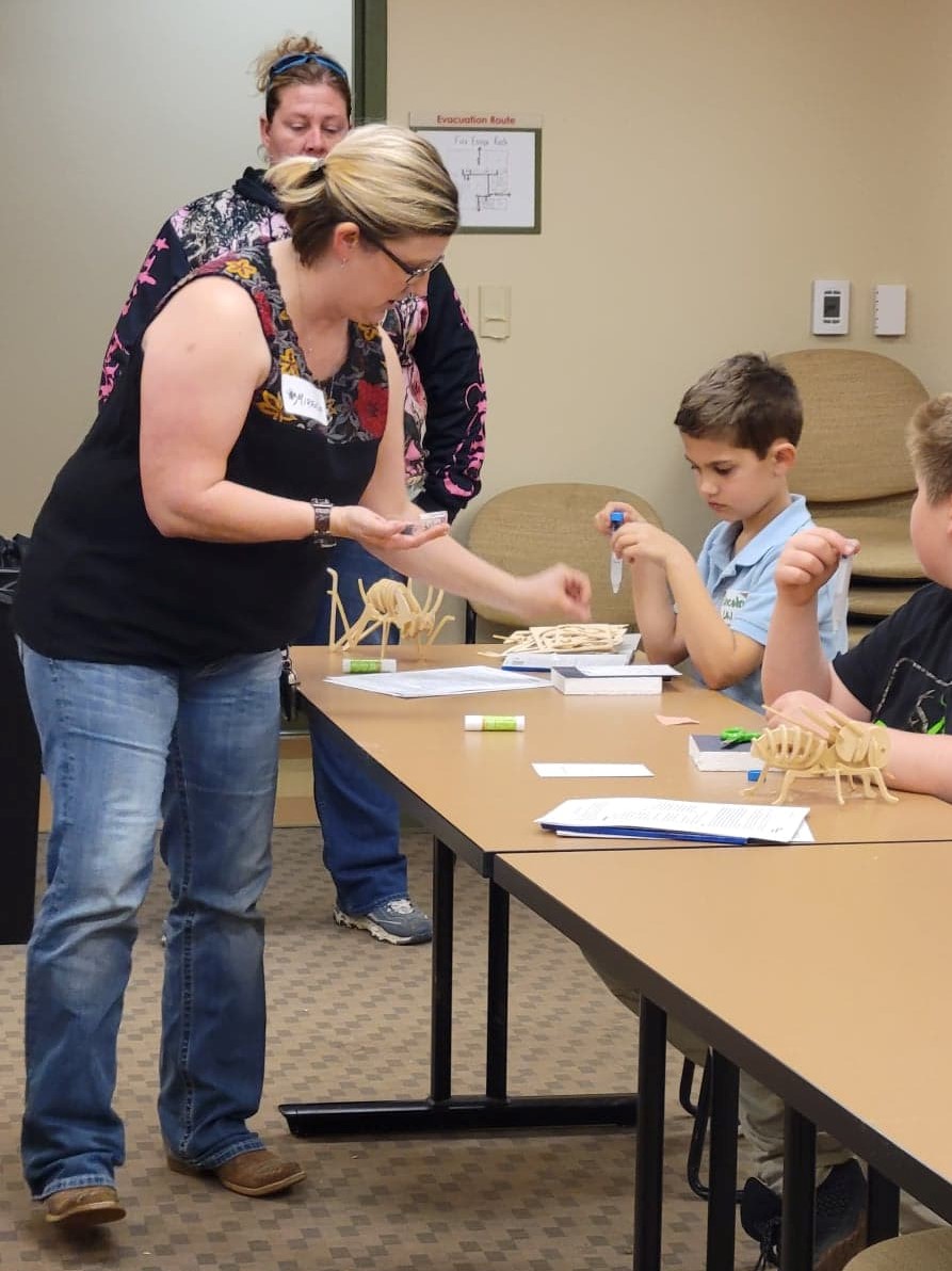 children at a table learning about bugs
