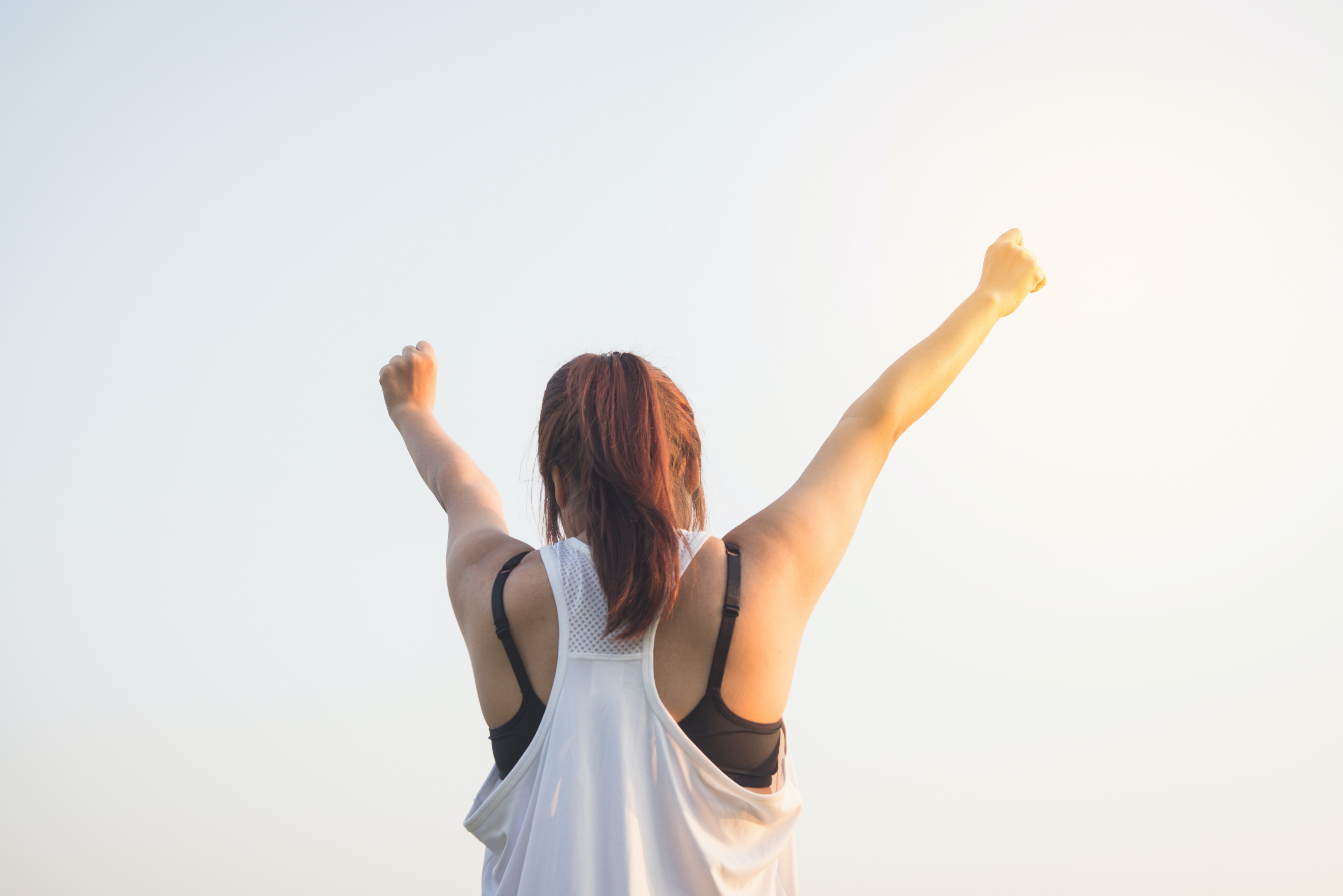 Woman with arms stretched out above her head