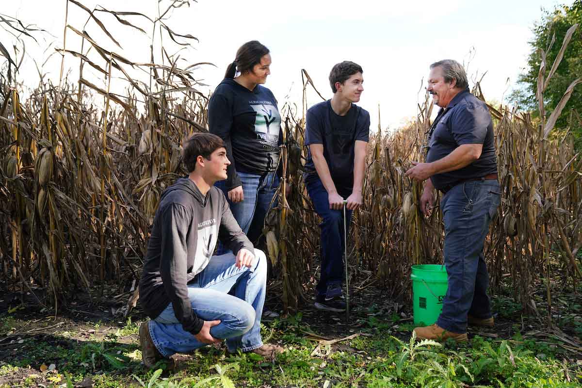 a group of students sampling soils