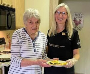 teacher and student holding their project
