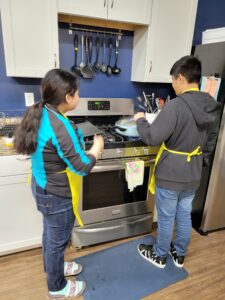 students facing a stove