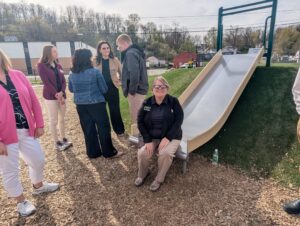 becky sitting on the park slide